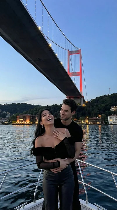 Romantic yacht embrace under the Bosphorus Bridge
