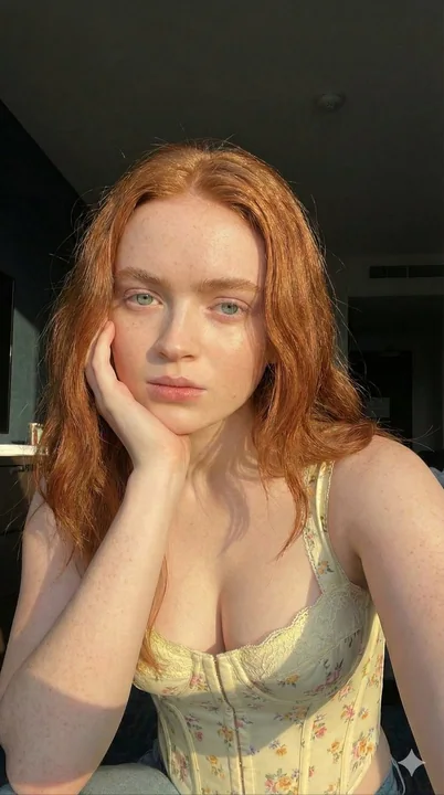 Close-up of a freckled blonde girl bathed in golden sunlight