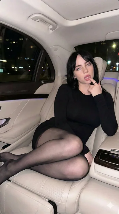 Red-haired seductress in the back seat of a luxury car