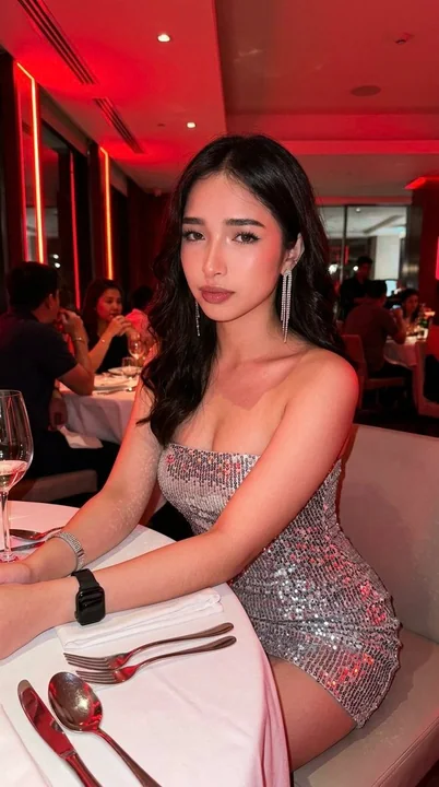 Silver sequin girl under the red neon lights