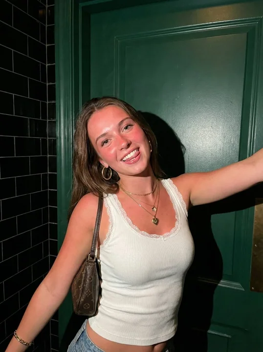 Playful spicy girl snapshot under a hard flash.