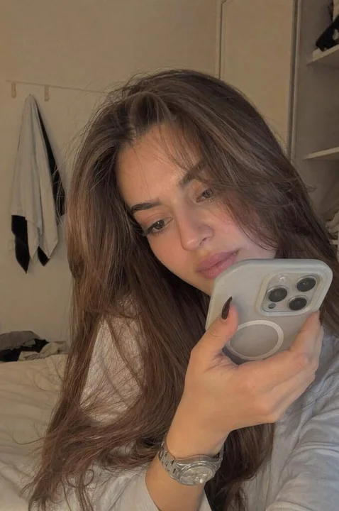 Shy girl recording a private video in the bedroom